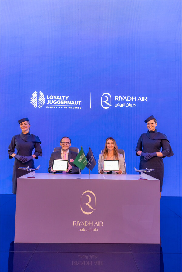 Displaying their commitment to a strategic alliance: James Mulroney, SVP of Client Engagement, Loyalty Juggernaut, and Kim Hardaker, Vice President of Customer Loyalty at Riyadh Air, present their signed agreement.